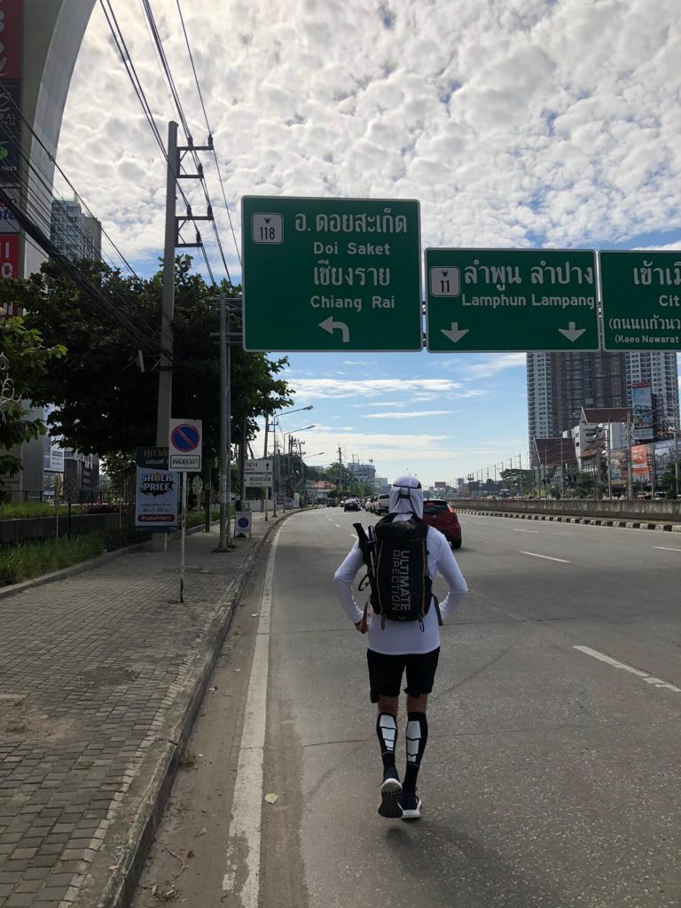 Man in sports gear running on a motorway.