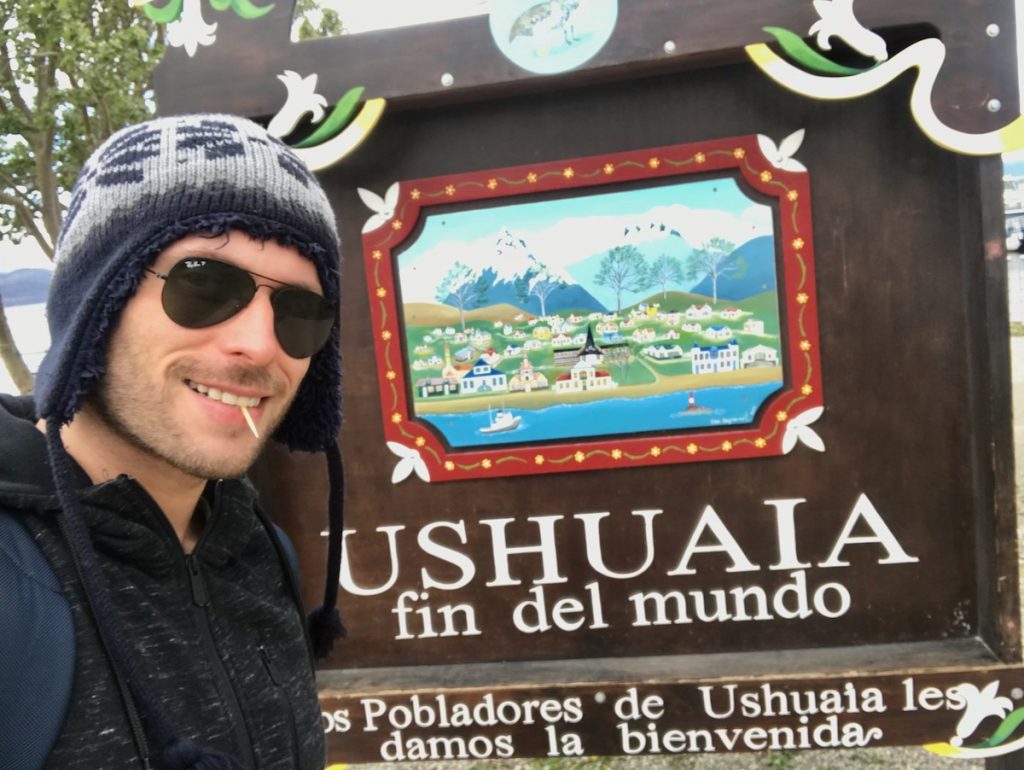 tourist at Ushuaia sign at the most southern point of Ushuaia 
