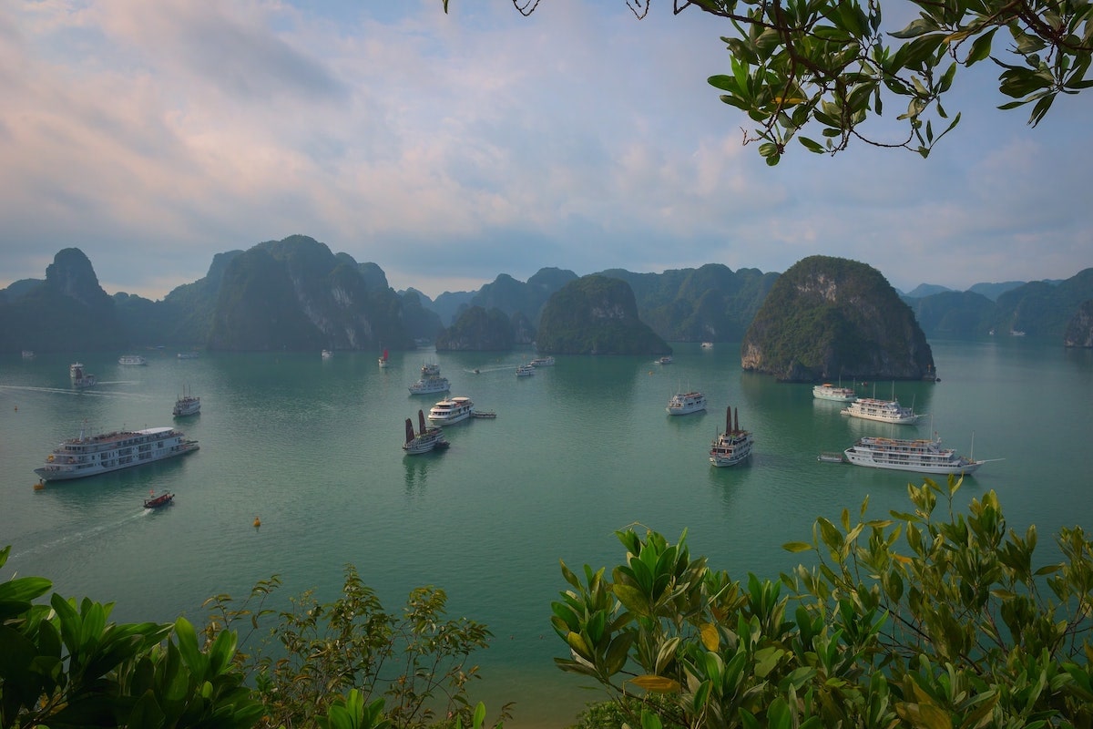 Best Vietnam Motorbike Routes: 5 Suggested Itineraries • ha long bay Boats passing through Ha Long Bay during the day
