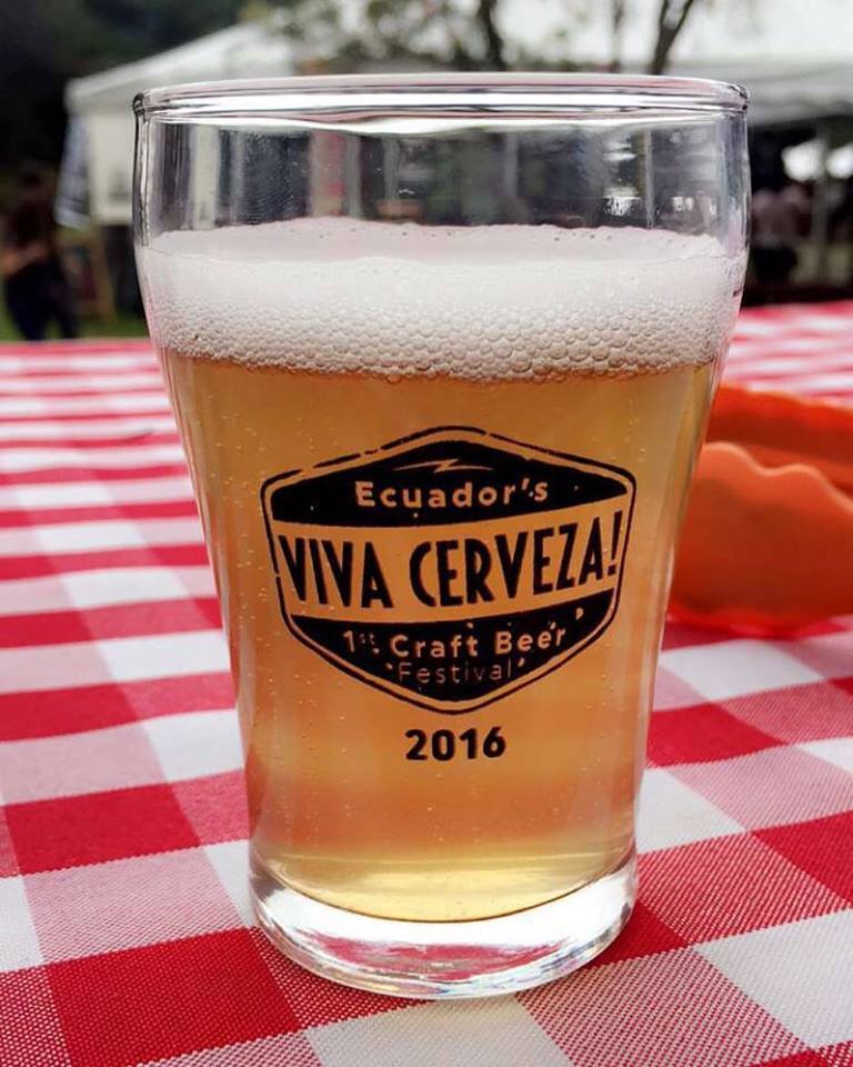 A pint of craft beer on a red and white table.