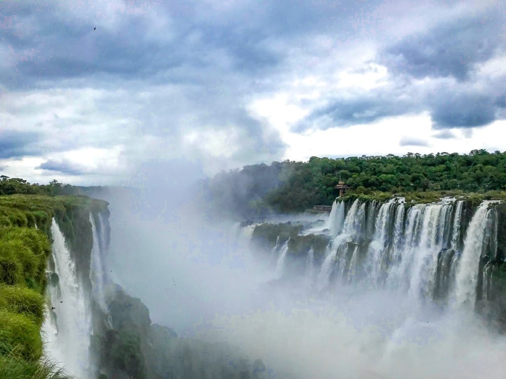 Mist falls over both sides of the Iguazu Falls Waterfalls, which are shared between Argentina and Brazil