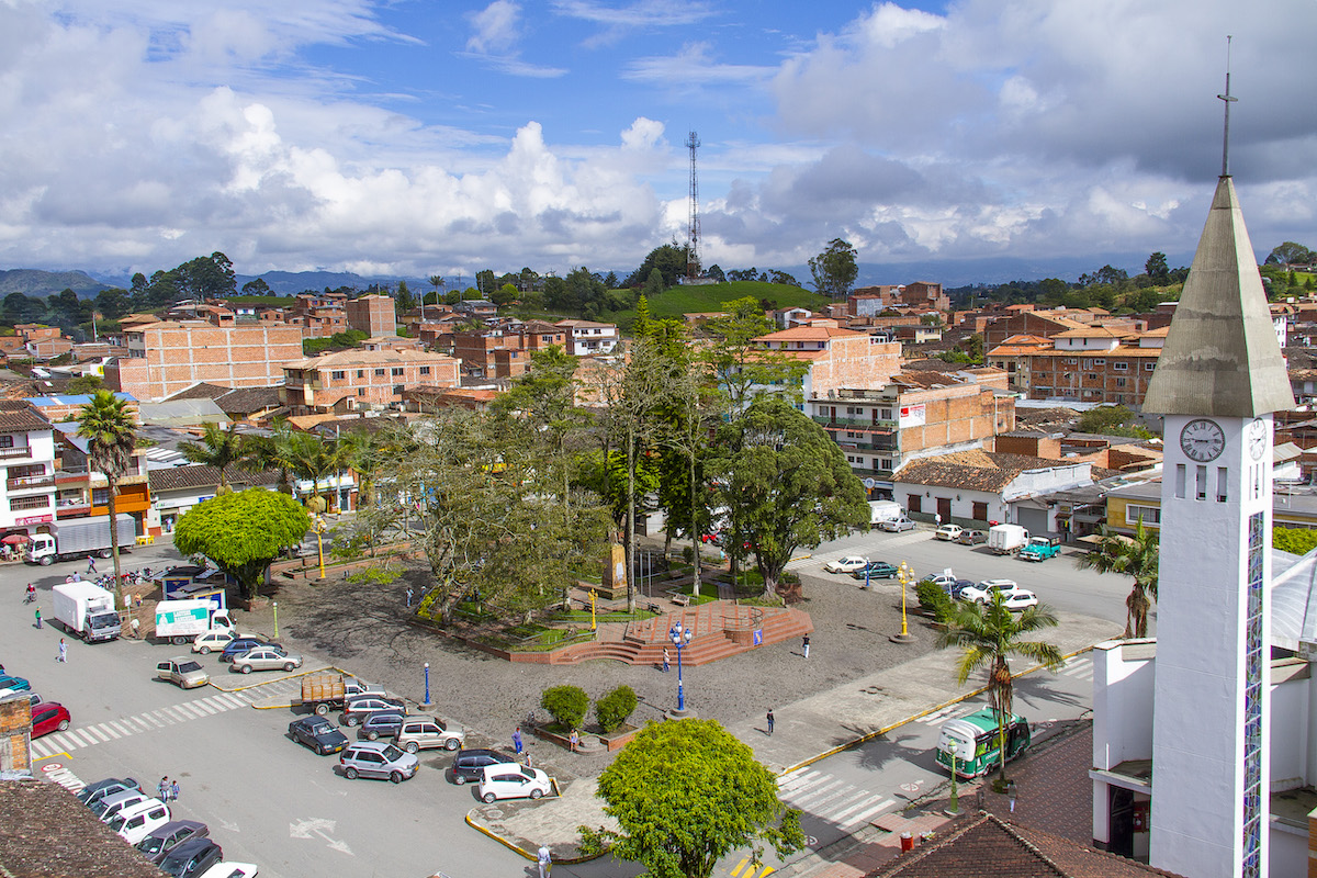 A panoramic view of a small urban park during the day