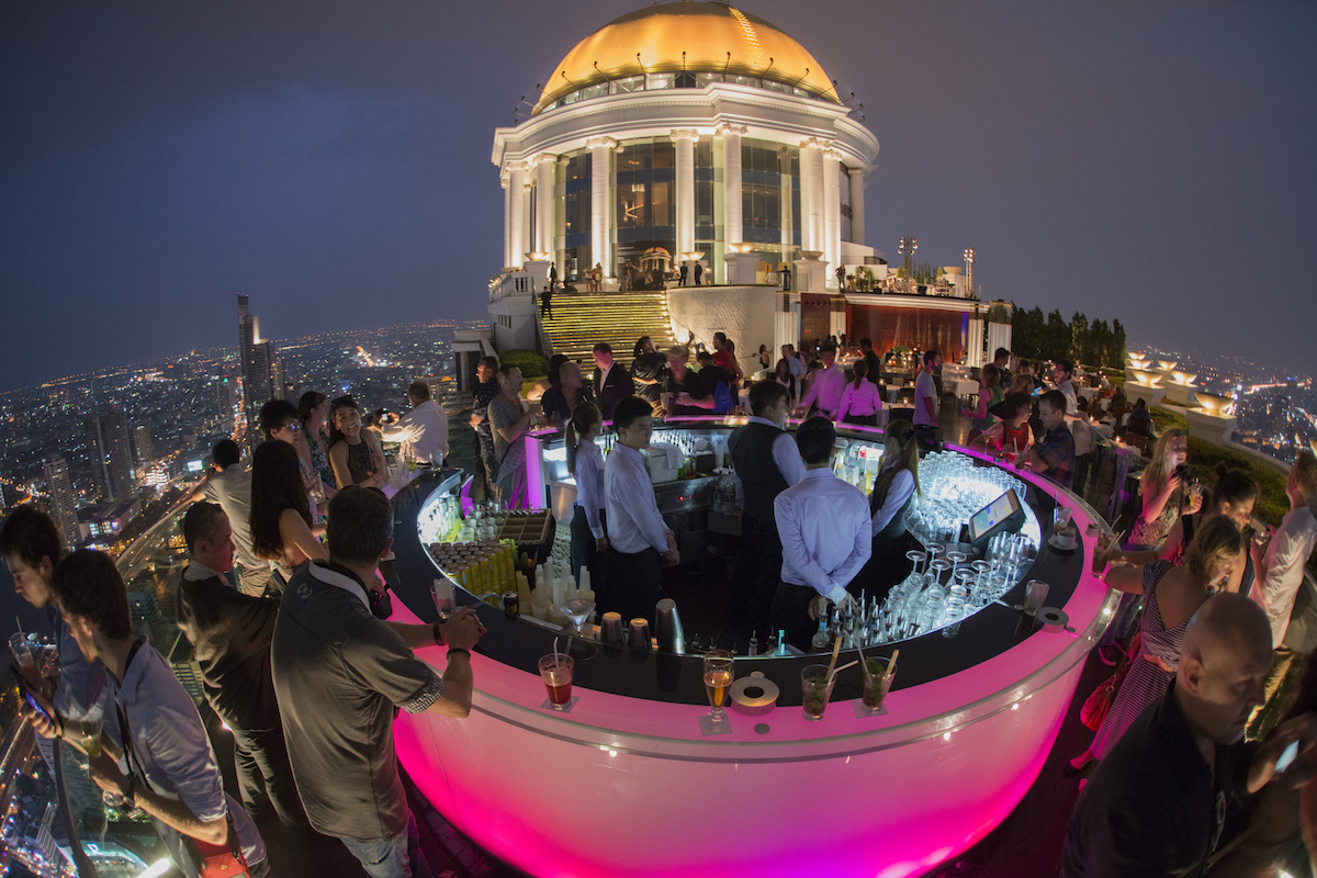 Cost of Living in Bangkok (& The Lies That Bloggers Tell) • Sky Bar Bangkok The famous pink Sky Bar at the Riverside Area in the city of Bangkok in Thailand, busy with staff and customers