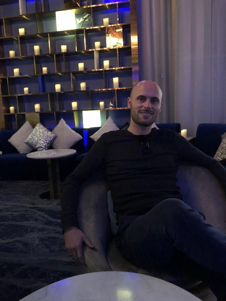 Cost of Living in Bangkok (& The Lies That Bloggers Tell) • image 10 A man in black smiling in a restaurant