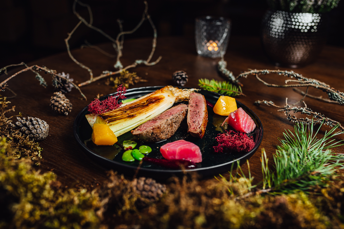 Cost of Living in Bangkok (& The Lies That Bloggers Tell) • luxury dining Fresh duck meat steak in Michelin star restaurant. Food table with forest decorations. Michelin food