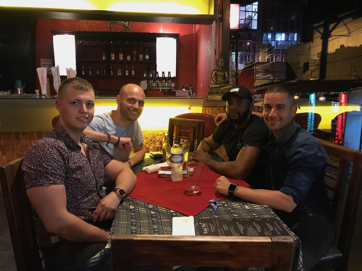 11 Honest Reasons To Learn Spanish in Medellin, Colombia • medellin Men sit at a table