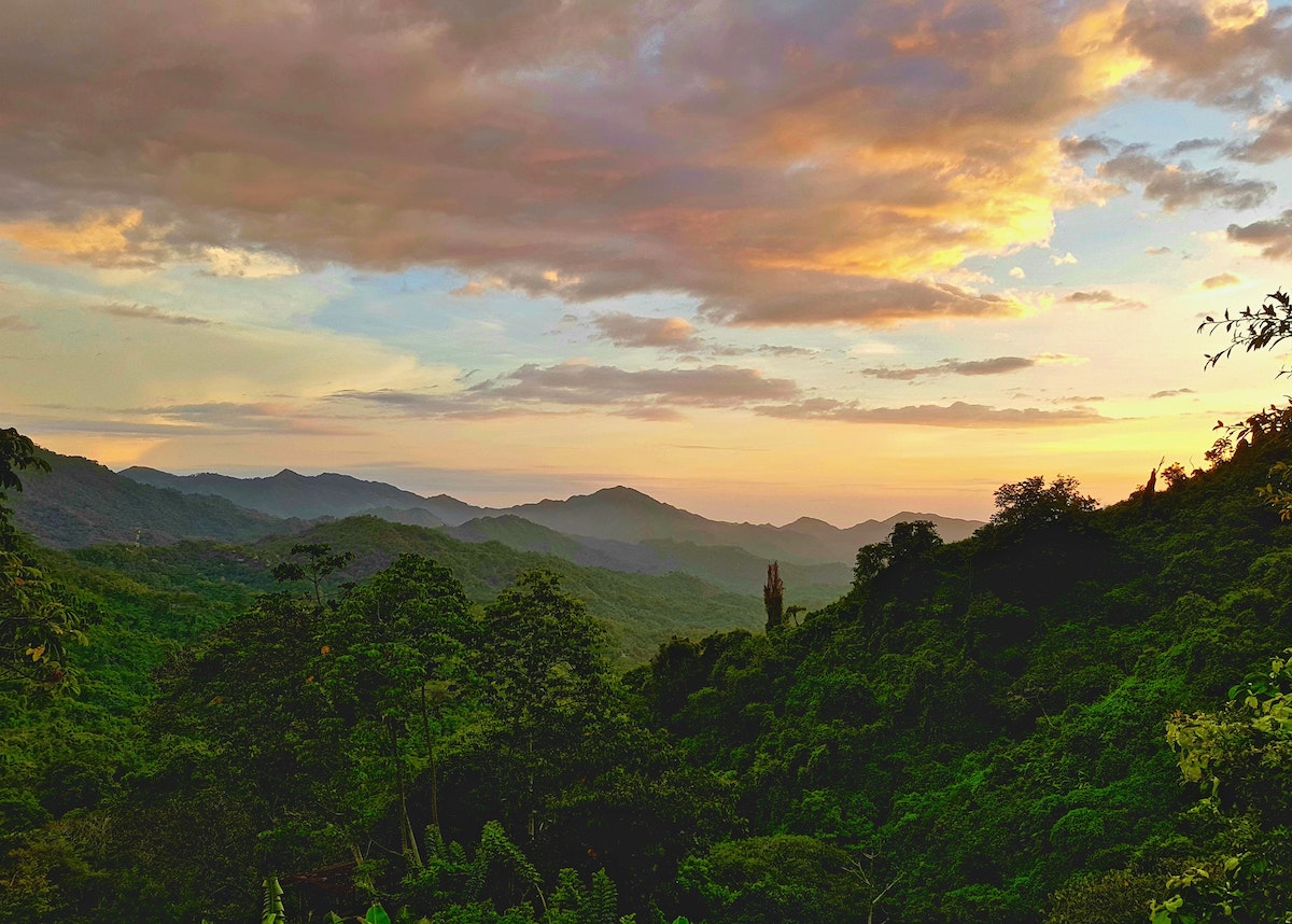 Red sky sunset overlooking gorgeous green hills in Minca, Colombia.