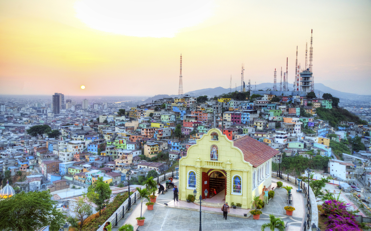 A gorgeous yellow church on top of a hill overlooking a busy, colourful barrio in Guayaquil, Ecuador.