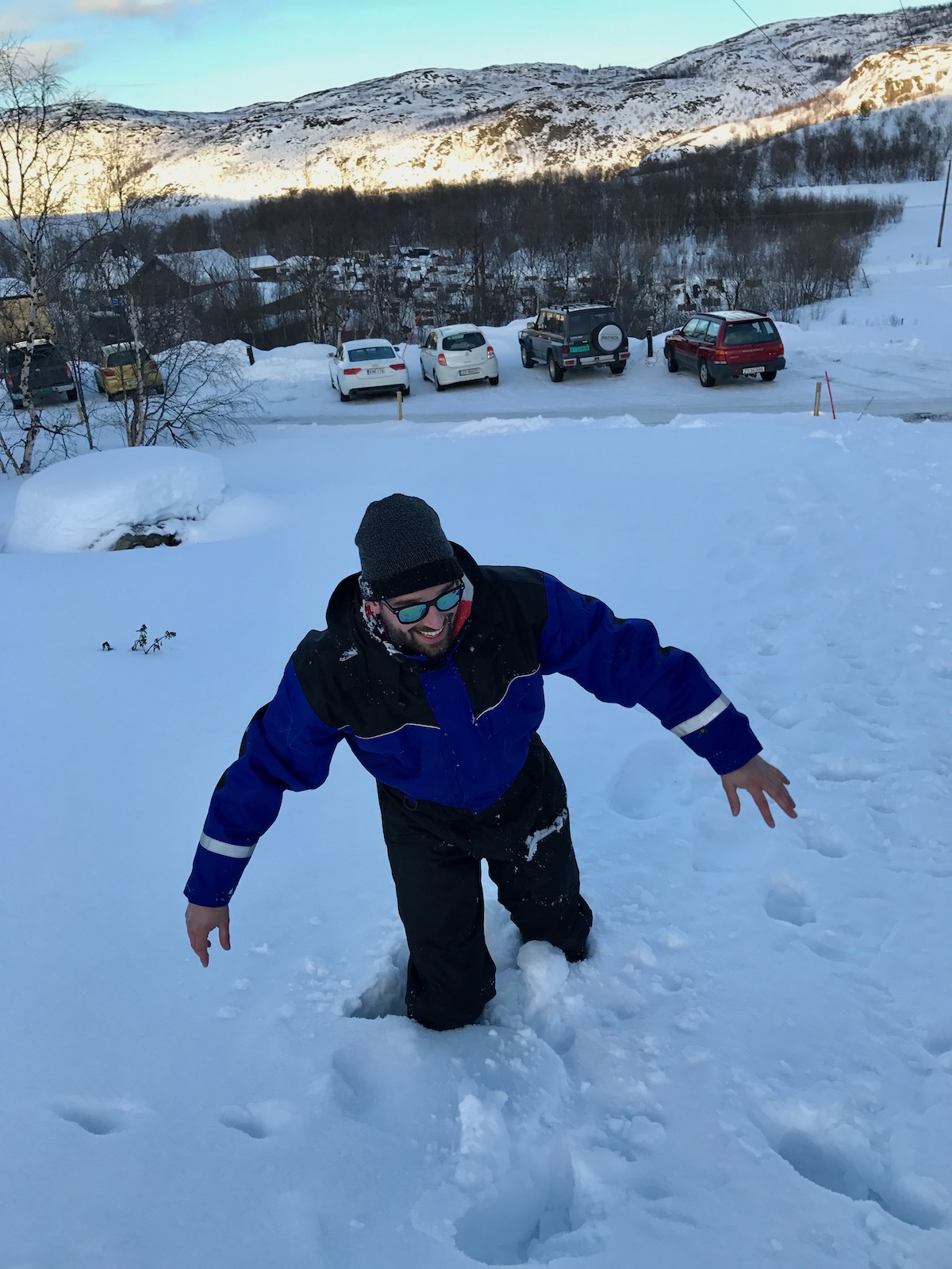 A man laughs while he is stuck in snow